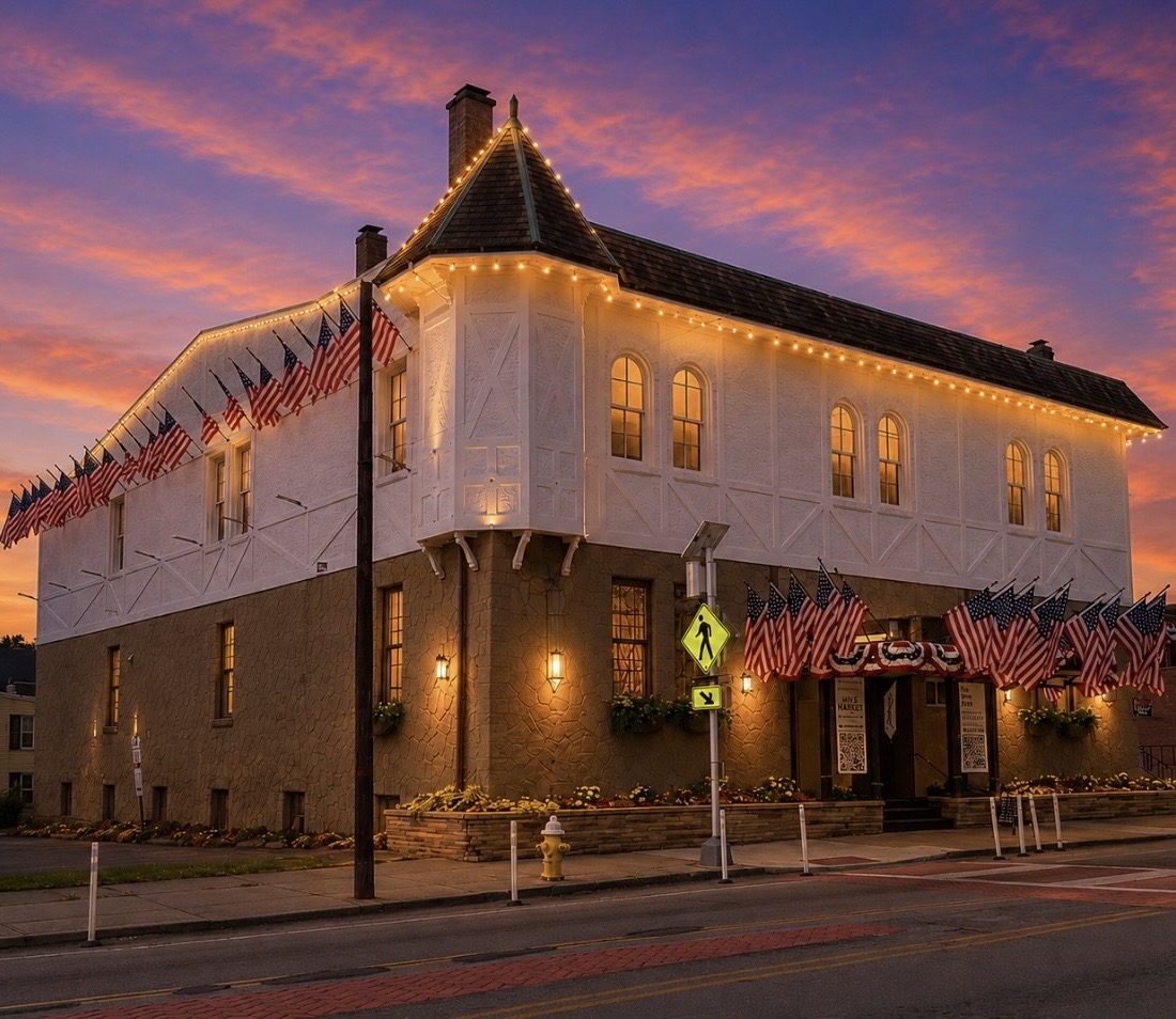 the HIVE Market building illuminated at sunset on Harrison Avenue in Cheviot